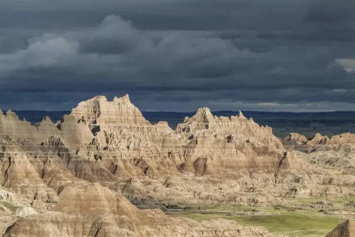 Framed Print : The eroded rocky formations of the Badlands region in South Dakota under a threatening