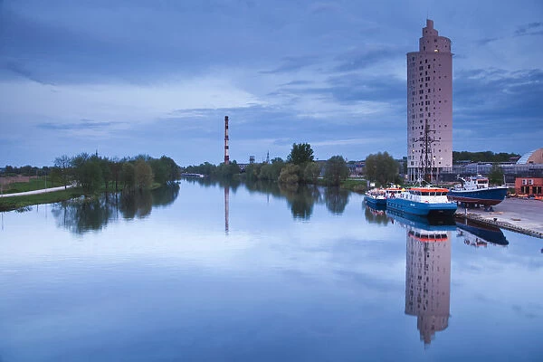 Estonia, Southeastern Estonia, Tartu, highrise building by Emajogi River, dusk