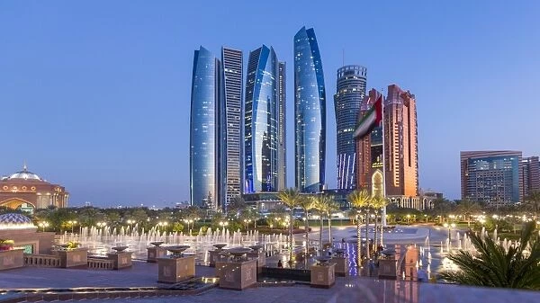 Etihad Towers time lapse viewed over the fountains of the Emirates Palace Hotel, Abu Dhabi