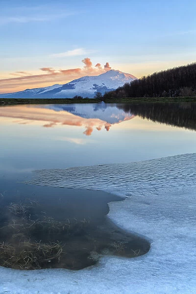 Etna is reflected in a lake in the Nebrodi mountains in Sicily, Italy