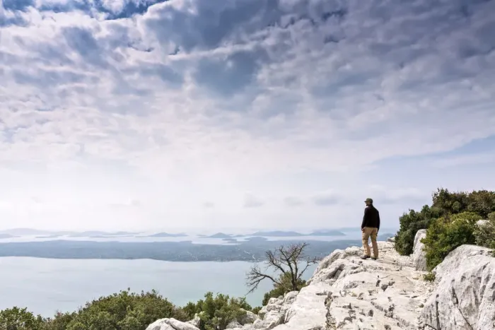 Framed Print : Europe, Croatia, Dalmatia, Zadar county, Kamenjak viewpoint, a hiker looking out over