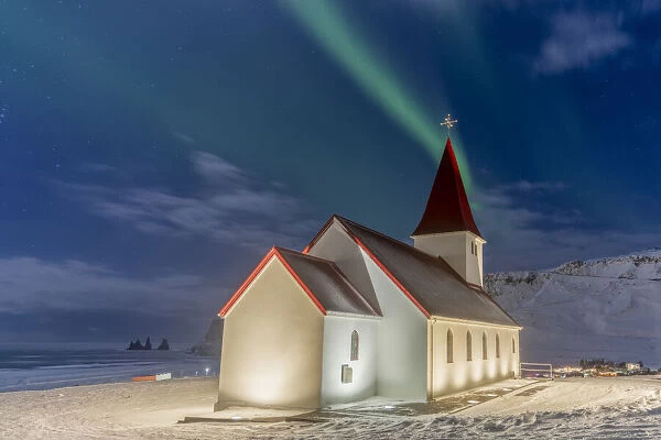 Europe, Iceland, Vik y Myrdal: the magic green of the Northern Lights over the Church and the rock pillars