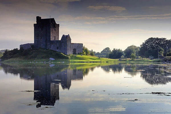 Europe, Ireland, Dunguaire castle at sunrise in Kinvara village reflecting in the