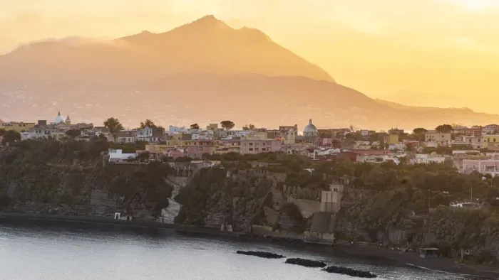 Framed Print : Europe, Italy, Campania. Procida island at sunset with the impressive Vesuvius in