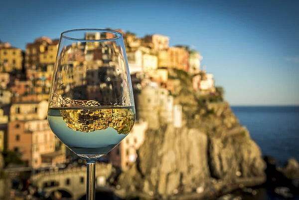 europe, Italy, cinque Terre. view of the village of Manarola with a reflection in