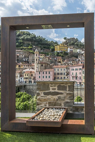 Europe, Italy, Liguria. Badalucco. A view of the town through a frame