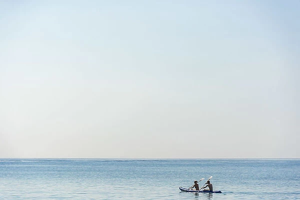 Europe, Italy, Liguria. Paddling a canoe in Monterosso, Cinque Terre