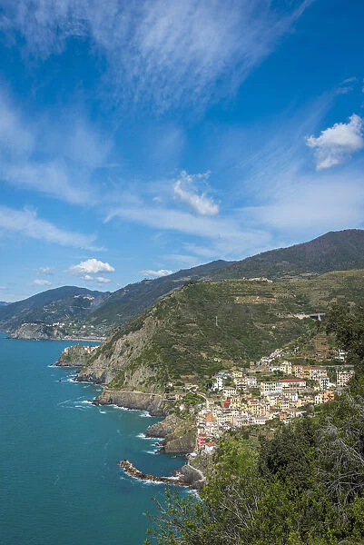 Europe, Italy, Liguria. View over the Cinque Terre coast with the village of Riomaggiore