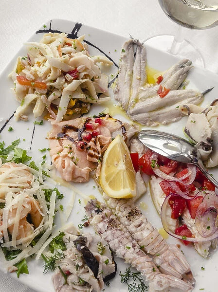 Europe, Italy, Marches. Mixed seafood platter for starter in a local restaurant