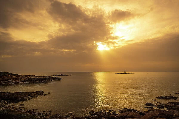 Europe, Italy, Sardinia. The lighthouse near to Calasetta on the island Sant'Antioco at sunset