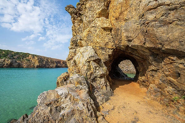 Europe, Italy, Sardinia. The rocky coast and the rock hole on Cala Domestica