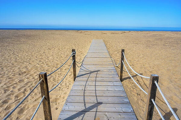 Europe, Italy, Sardinia. A wooden gangway to the long sandy beach of Piscinas