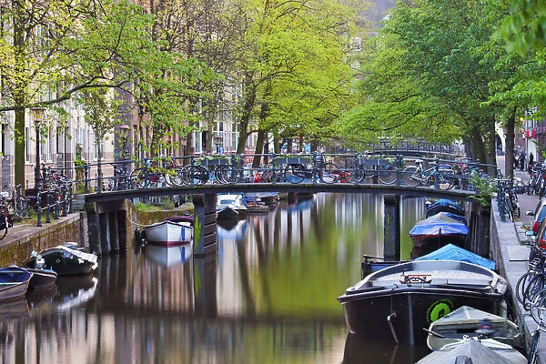 Europe, Netherlands, Holland, Amsterdam, canal boats on the canal and bicycles