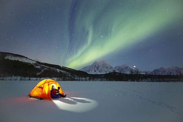 Europe, Norway, Troms: winter camping under the northern lights in the Lyngen Alps