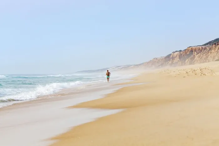 Framed Print : Europe, Portugal, Alentejo, Grandola, a man running along Praia da Gale beach near Framed Print : Europe, Portugal, Alentejo, Grandola, a man running along Praia da Gale beach near