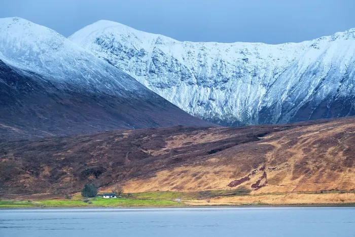 Framed Print : Europe, UK, Scotland, Isle of Skye, crofters cottage set against dramatic snowy mountains and a sea loch Framed Print : Europe, UK, Scotland, Isle of Skye, crofters cottage set against dramatic snowy mountains and a sea loch