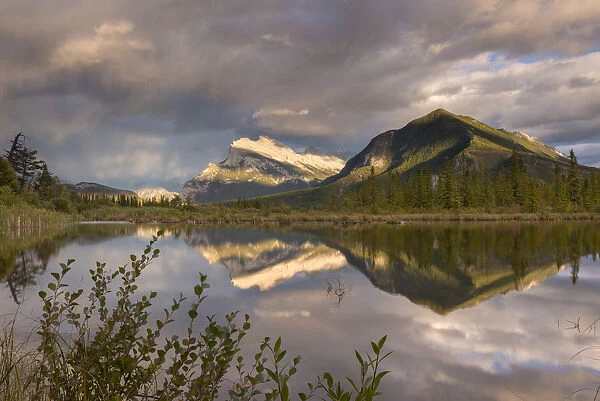 Evening light glows on Mount Rundle, reflected in Vermillion Lakes in the Canadian