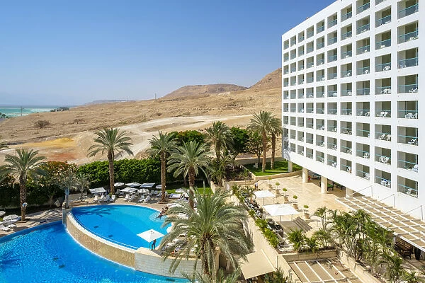 Exterior of hotel with swimming pool and palm trees, Ein Bokek, Southern District, Israel
