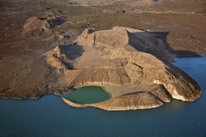 Framed Print : An extinct volcanic crater, Abil Agituk, at the southern end of Lake Turkana has a distinctively green crater lake which is fed by underground seepage from Framed Print : An extinct volcanic crater, Abil Agituk, at the southern end of Lake Turkana has a distinctively green crater lake which is fed by underground seepage from