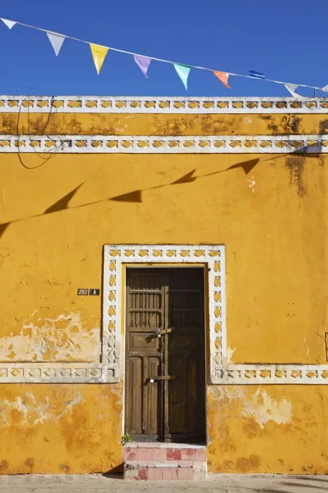 Framed Print : The front facade of a colonial house in Izamal, Yucatan, Mexico Framed Print : The front facade of a colonial house in Izamal, Yucatan, Mexico