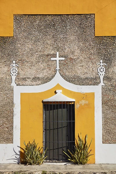 The front facade of a colonial house in Izamal, Yucatan, Mexico