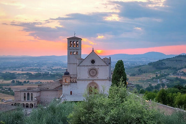 The facade of upper Basilica of Saint Francis of Assisi at sunset, Assisi, Perugia province, Umbria, Italy