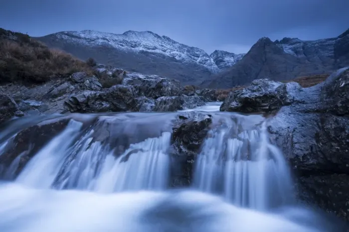 Framed Print : Fairy Pools waterfalls at Glen Brittle, with the snow dusted Cuillin mountains beyond Framed Print : Fairy Pools waterfalls at Glen Brittle, with the snow dusted Cuillin mountains beyond