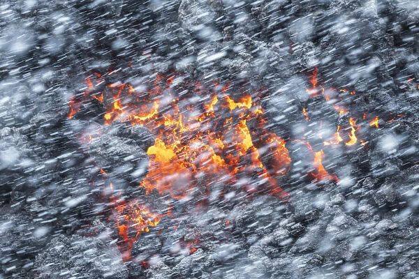 Falling snow and lava coming from the Fagradalsfjall eruption