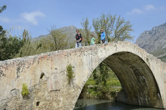 Framed Print : Family moves over the arch bridge over the River Megalopotamos the Preveli, Crete Framed Print : Family moves over the arch bridge over the River Megalopotamos the Preveli, Crete