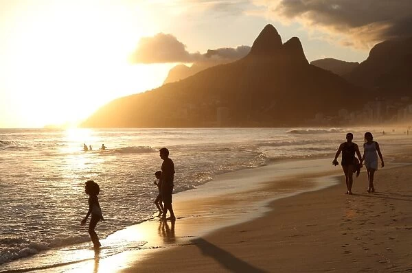 The famous Ipanema Beach in Rio de Janeiro with the Two Brothers Mountain in the background at sunset
