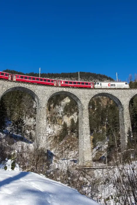Framed Print : The famous red train of Albula mountain railway while passing on the Landwasser viaduct