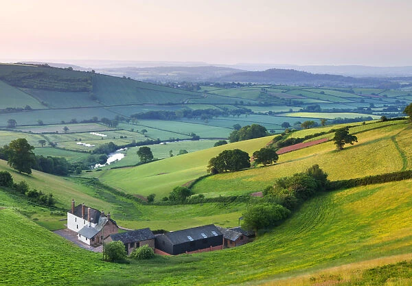 Farm nestled in the Exe valley overlooking the River Exe, Devon, England. Summer