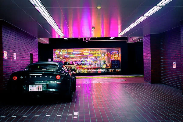 Fast car and neon signs in the streets on Tokyo, Japan