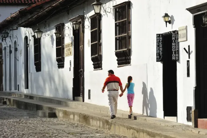 Framed Print : Father and daughter walking in the Colonial town of Giron, Colombia, South America