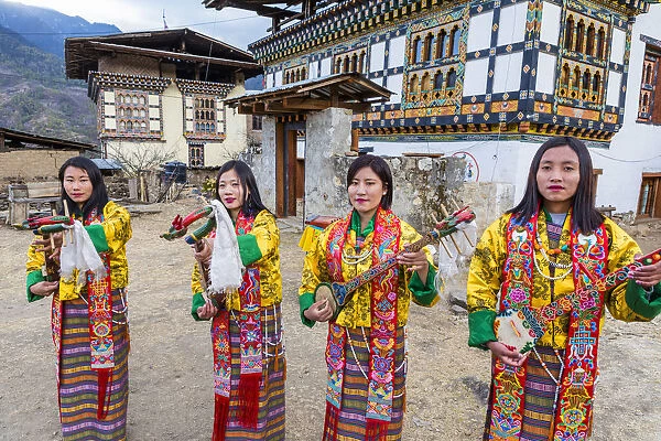 Female performers playing instruments at a local festival in Paro District, Bhutan