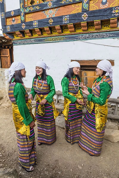 Female performers talking at a local festival in Paro District, Bhutan