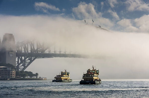 Ferries and Sydney Harbour Bridge in fog, Sydney, New South Wales, Australia