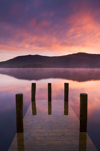 Fiery sunrise over Derwent Water from Hawes End jetty, Lake District National Park