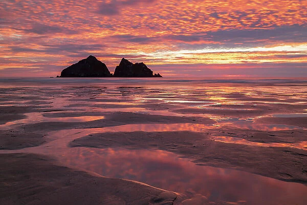 Fiery sunset sky above Holywell Bay on the North Cornwall Coast, England. Summer (July) 2018