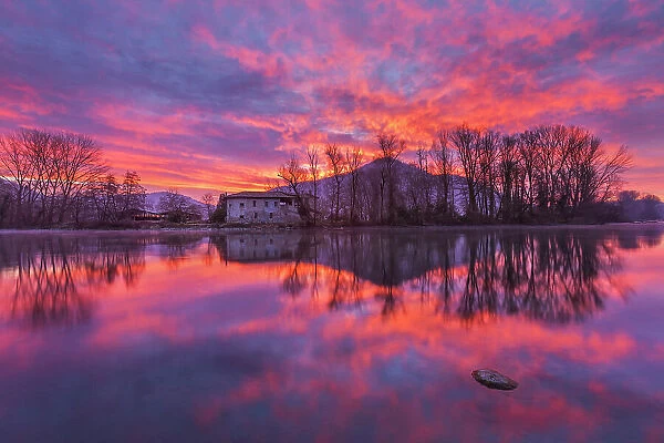 Fire sunrise on the Adda river, Brivio, Lecco province, Lombardy, Italy
