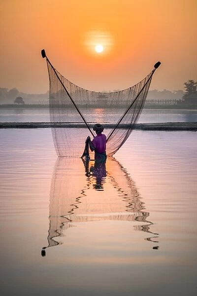Fisherman fishing in the Taungthaman lake in Amarapura, Mandalay, Myanmar