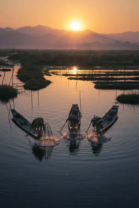 Framed Print : Three fishermen catching fish from boats using traditional conical nets at sunrise