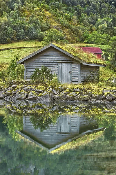 Fishermen hut mirrored in lake - Norway, Sogn og FjordaneNordfjord, Stryn, Strynevatnet