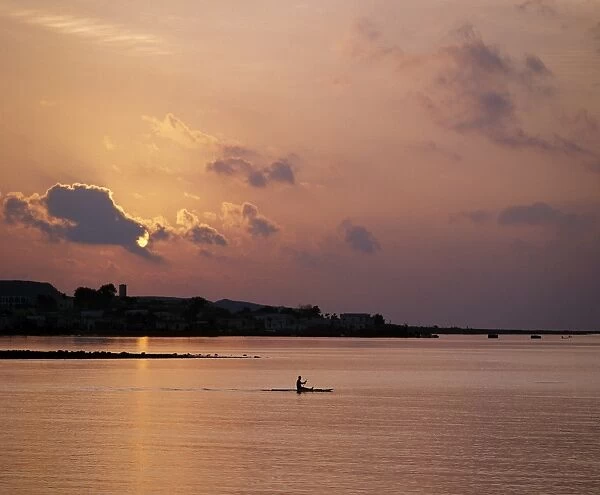 A fishermen paddles his small boat across Tadjoura Bay at sunrise