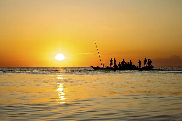 Fishermen returning home on dhow at sunset, , Indian Ocean, Zanzibar, Tanzania