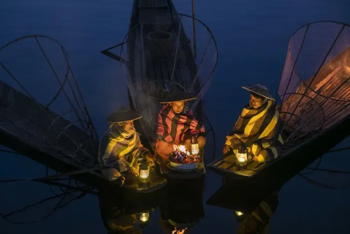 Framed Print : Three fishermen sitting on their boats warming up around a fire before sunrise, Lake Inle Framed Print : Three fishermen sitting on their boats warming up around a fire before sunrise, Lake Inle