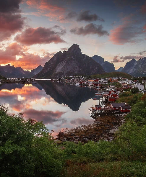 The fishermen's village of Reine and its fjord on a calm summer evening taking the last light of the day. Lofoten Islands, Norway