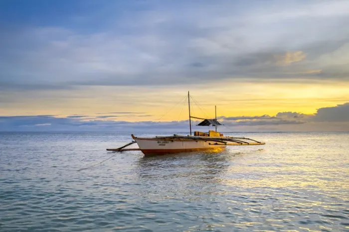 Framed Print : Fishing boat anchored at Paliton Beach, San Juan, Siquijor Island, Central Visayas