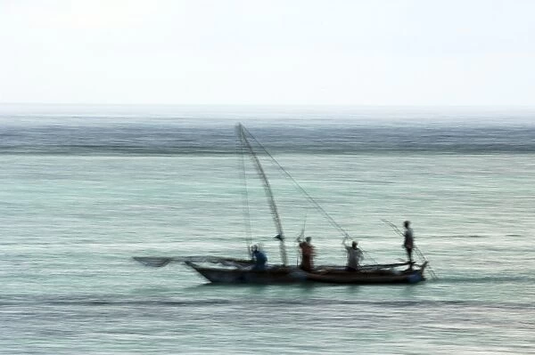 Fishing boat in the Indian Ocean, pre-dawn, East Coast Unguja Island, Zanzibar, Tanzania