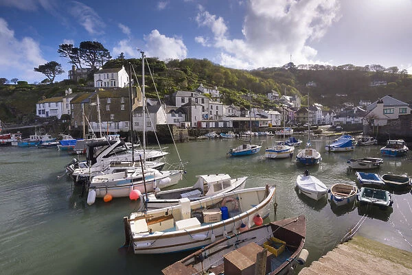Fishing boats moored in picturesque Polperro harbour on a sunny Spring evening, Cornwall